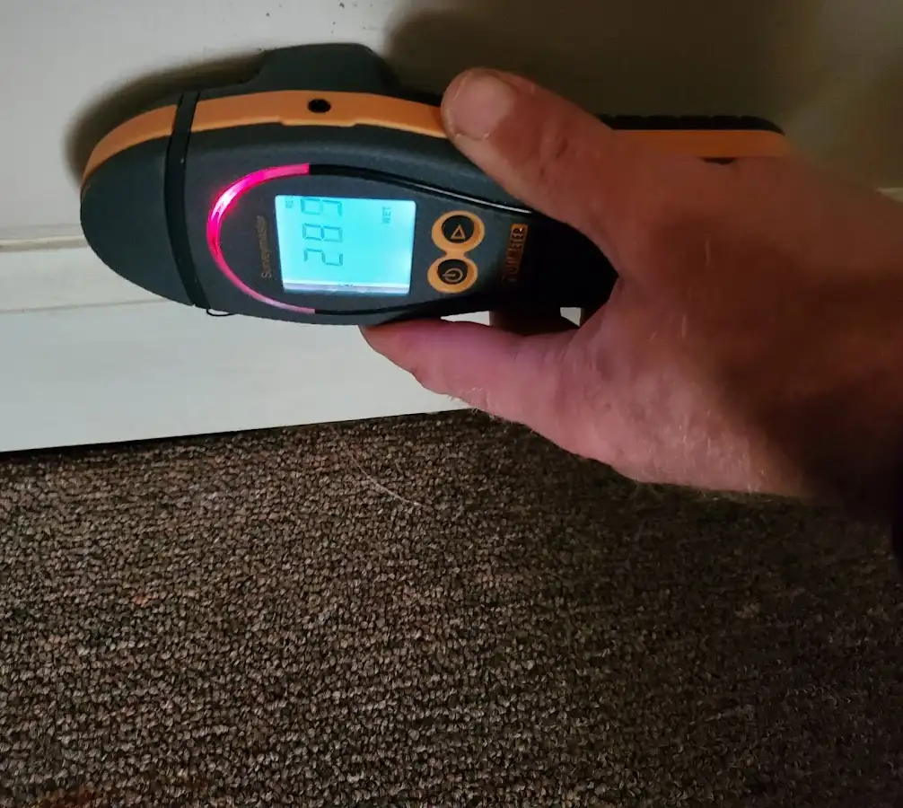 Moisture detection at baseboard during Storm Damage Restoration in Finley